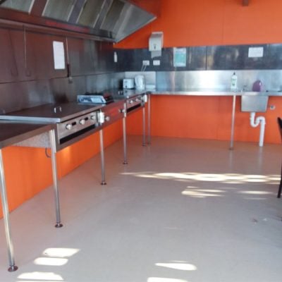 Covered outdoor barbecue area at Smoky Bay Caravan Park with picnic tables and built-in gas BBQs