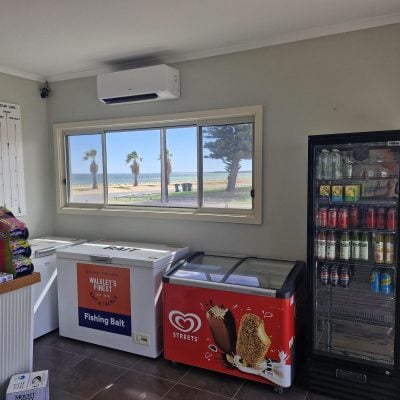 caravan park kiosk with service counter, sells chips, ice cream, fishing bait, and cold drinks