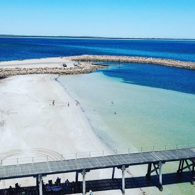 Boats anchored near Smoky Bay jetty with boat ramp and shoreline in the background