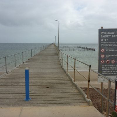 View of Smoky Bay jetty stretching over calm ocean water